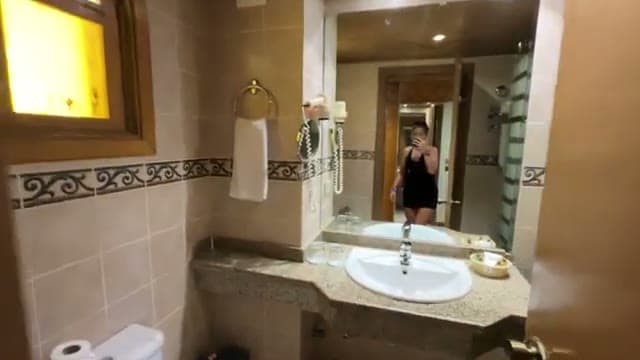 Il bagno della camera del Dive Inn con il lavabo in granito, lo specchio e le mattonelle decorate