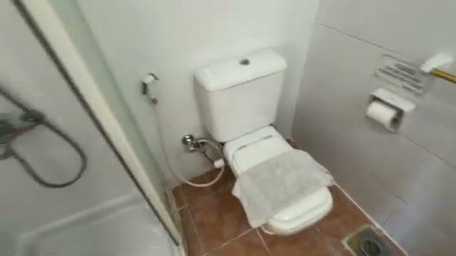 Il bagno essenziale dell'Oonas Dive Club, con doccia e sanitari semplici ma puliti