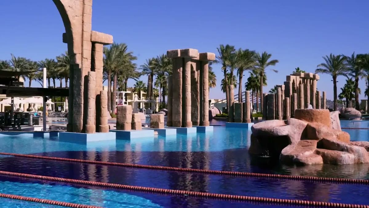 Una delle piscine del Rixos Premium Seagate con le colonne in stile egizio, le palme e le corsie per nuotare