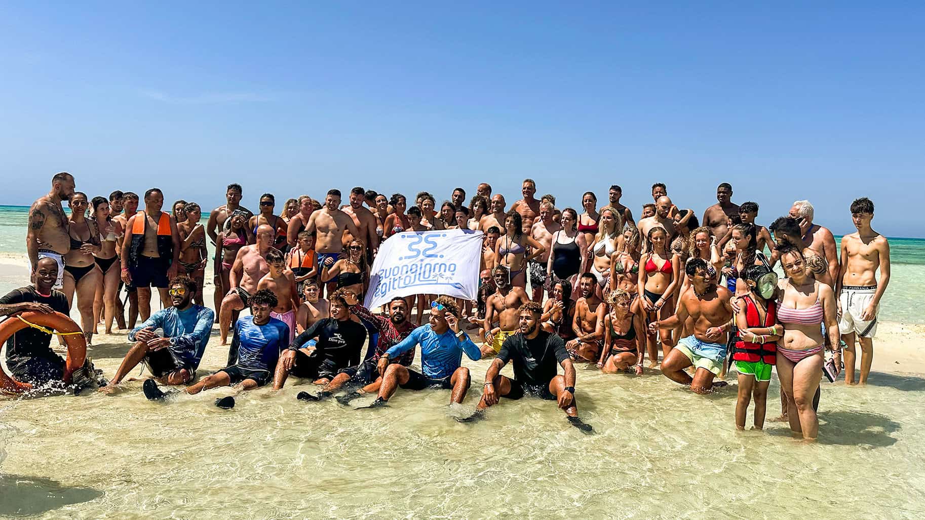 All' isola che non c' e' un gruppo di clienti con guida e guida snorkeling in posa per una foto